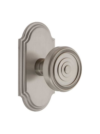 Grandeur Arc Rosette Door Set with Soleil Knobs in Satin Nickel.